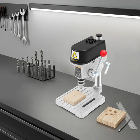 Powerful 340W Benchtop Drill Press With 3 Speed Corded Mini Drill For DIY Metal And Plastic Projects on a workbench with wooden blocks.