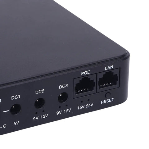 Heavy Duty Ups Power Supply With 10400Mah Portable Battery Backup, black battery unit with ports for security cameras and routers.