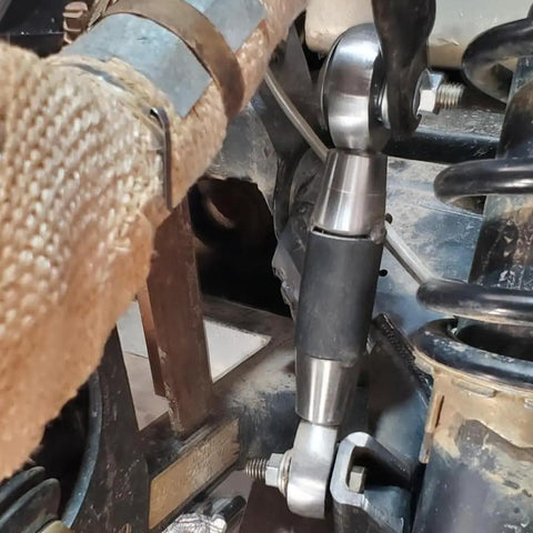 Close-up of Beefed Up 1/2 Inch Heim Joints Rod End Kit with Chromoly Panhard adapter installed on vehicle suspension system