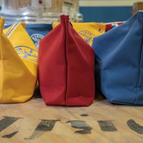 Large 16-Inch Canvas Tool Pouches 3-Pack with Brass Zippers and Hanging Grommets, Red Yellow Blue, on wooden surface