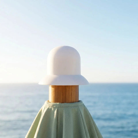Stylish Patio Umbrella Top Cap Replacement Kit For Outdoor Canopies With Wind Resistance And Easy DIY Installation To Save Cash On Backyard Sun Shades. White top cap on wooden patio umbrella pole by the sea