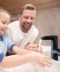 Child and adult using Matte Black Bathroom Faucet With Modern Waterfall Spout, 360 Degree Swivel, Single Hole Deck Mount, ABS Construction