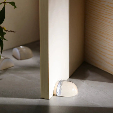 Heavy Duty Acrylic Door Stopper 4 Pack No Drill Sticky Wall Bumpers smooth clear bumpers protecting wall corner in home setting.