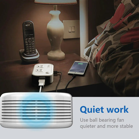 Voltage Converter 220V To 110V Travel Step Down with 4 USB Charging Ports next to a phone and lamp, nighttime setting