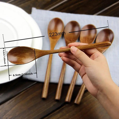 Hand holding spoon from Six Piece Japanese Natural Wooden Spoons Set For Cooking And Eating Great For Stirring Tea Honey Soda Dessert And Nonstick Pots Made From Nanmu Wood About Eight Point Seven Eight Inches Long Eco Friendly Kitchen Tools.