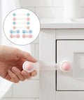 Eight Pack Cabinet Safety Locks For Babyproofing Closets And Fridges Durable ABS Material With Easy Adult Unlock Strong Adhesive No Drill Install Ideal For Pantry And Laundry Areas Keep Kids Safe While You Stay In Control shown securing a cabinet door.