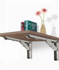 2 Piece Heavy Duty Folding Shelf Brackets Wall Mount supporting a wooden shelf with books and flowers, rugged stainless steel design.