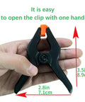 Hand holding 10-Pack 3.4 Inch Plastic Spring Clamps Heavy Duty For Crafts Backdrop Clips and Photo Stand
