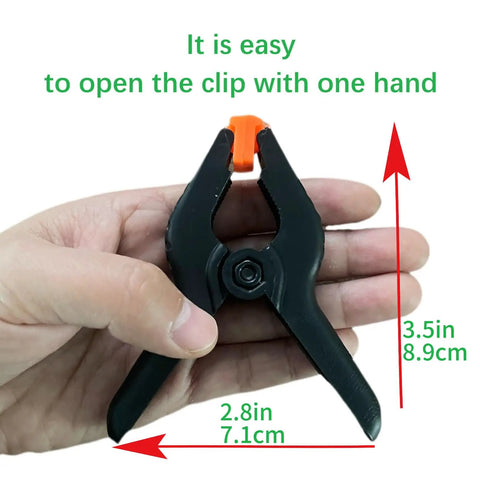 Hand holding 10-Pack 3.4 Inch Plastic Spring Clamps Heavy Duty For Crafts Backdrop Clips and Photo Stand
