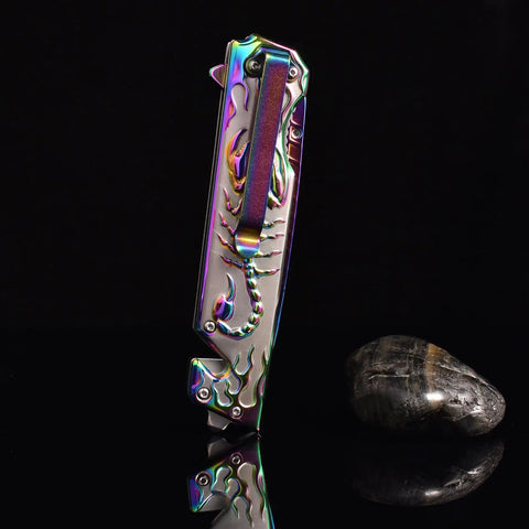 Folding Pocket Knife With 3D Titanium Plated Scorpion Handle Dope Rainbow Finish shown closed on black background