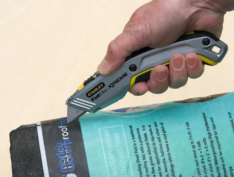 Pro Twin Blade Retractable Utility Knife With Interlock Safety Lock 2 In 1 Cutting Tool in hand, cutting waterproof packaging