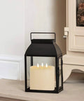 Extra Large 6x6 Flameless Candles With Three Wicks Battery Operated LED Pillar Candles With Remote And Timers Real Wax Ivory shown in a lantern