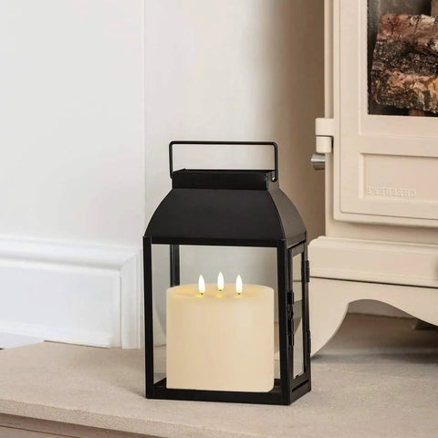 Extra Large 6x6 Flameless Candles With Three Wicks Battery Operated LED Pillar Candles With Remote And Timers Real Wax Ivory shown in a lantern