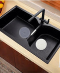 Slick Six Inch Silicone Tub Stopper Two Pack Soft Drain Plug Hair Catcher in black sink blocking clogs while washing.