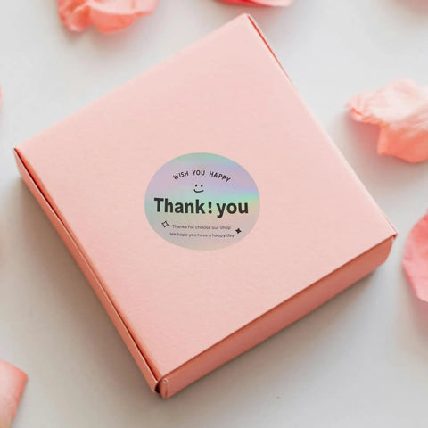 Pink gift box with a Thank You Stickers For Packaging And Gift Wrapping, Sturdy Copper Plate Self Adhesive Sealing Labels on top.