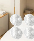 No Sweat Peel And Stick Appliance Casters 8 Pack Built Tough Ball Wheels group on a table, showing white durable casters.