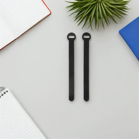 Super Solid 100 Piece Pack Of Self Adhesive Nylon Cable Ties With Cute Round Heads on a grey surface with notebooks.