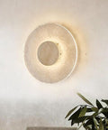 Wall Sconce Modern Indoor Round LED Nordic Hall Natural Stone Vintage Industrial Hallway Fixture Yellow Travertine Mid Century Farmhouse for Living Room Bedside against a light wall.