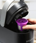 Inserting a reusable pod with a Disposable K Cup Filter Paper For Keurig Brewers 1.0 And 2.0 into a Keurig machine