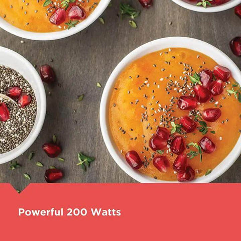 Black Two Speed Immersion Blender with Heavy Duty Stainless Steel Blades and Ergonomic Handle Easily Purees Soups in bowls with toppings.