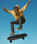 Skateboarder performing a trick, using contour map grip tape for skateboards 33 by 9 inches, black with white contour lines.