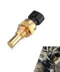 Close-up of brass automotive water temperature sensor with threaded stem and black connector; inset shows it installed in an engine bay.