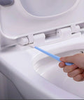 Hand using a Disposable Crevice Cleaning Tool Set With 50 Replaceable Brush Heads For Tight Gaps, Baseboards, Window Tracks, Door Grooves And Grout, Deep Detail Cleaning Kit For A Fresh Dirt Free Home on toilet hinge.