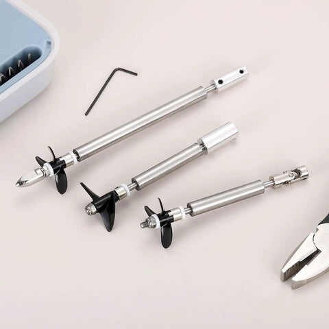 RC Boat Drive Shaft Kit With 36mm Propeller And Universal Joint, 100mm Shaft, 25mm Sleeve, shown with tools on a table.