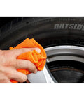 Applying Solid Alloy Wheel Repair Kit For Black Rims Smooths Out Curb Rash And Road Scuffs DIY on a silver alloy wheel.