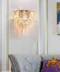 Drip Up Your Wall Decor Game With This Modern Crystal Wall Sconce Featuring A Solid Metal Build And Versatile E14 Socket. A Must Have Wall Accent Light For Bedroom, Living Room, Hallway Refresh. Crystal sconce mounted on wall above a couch.