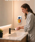 Portable 450W Plug In Heater With Remote in bathroom wall outlet near woman washing hands