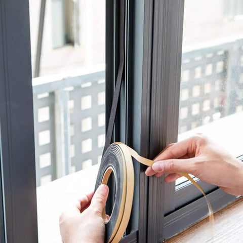Person applying Heavy Duty Neoprene Foam Seal Tape 3 Pack 1/2 Inch Wide By 1/8 Inch Thick 59 Feet Total on window frame.