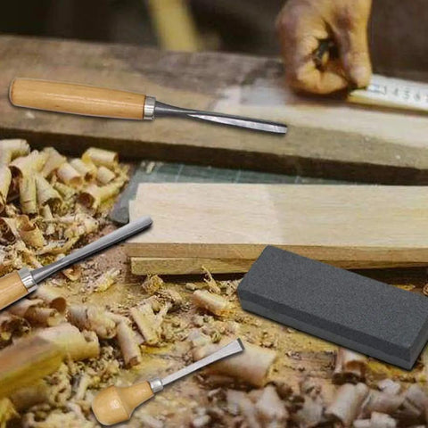 Heavy Duty 16 Piece Wood Carving Tool Set With Premium Handles Sharp Chisels And Gouges Includes Wooden Mallet And Whetstone on a workshop table.