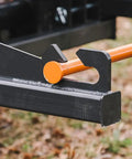 Close-up of Skid Steer Sod Roller with Adjustable 36in 44in 52in Widths, showcasing universal quick tach attachment on grass.