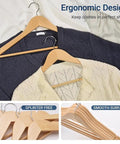 Straight Up Premium Quality Natural Wooden Coat Hangers Thirty Pack Flat Profile Wood Suit Hangers with sweaters placed on them.