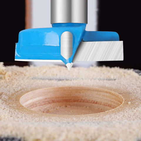 Blue hex-shank carbide-tipped hinge boring hole saw cutter, front view drilling a 22mm hole in wood.