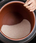 Ceramic Rice Dispenser With Heavy Duty Snap Lid Airtight Bulk Food Storage Container filled with sugar inside, taken from above.