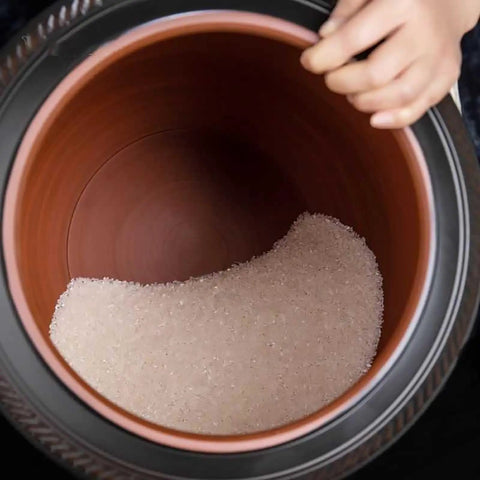 Ceramic Rice Dispenser With Heavy Duty Snap Lid Airtight Bulk Food Storage Container filled with sugar inside, taken from above.