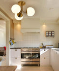 Three Light Aged Brass Semi Flush Mount Ceiling Light Fixture With White Globe Glass in modern kitchen setting