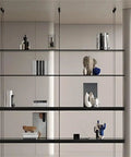Sleek Black Four Tier Wall Mounted Storage Rack With Solid Aluminum Alloy Shelves For Living Room Decor Vintage Style Hanging Bookcase displaying books and decorative items.