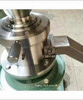 Close-up of JM120 Commercial Vertical Peanut Butter Grinder Mill in Stainless Steel output chute and mechanical details.