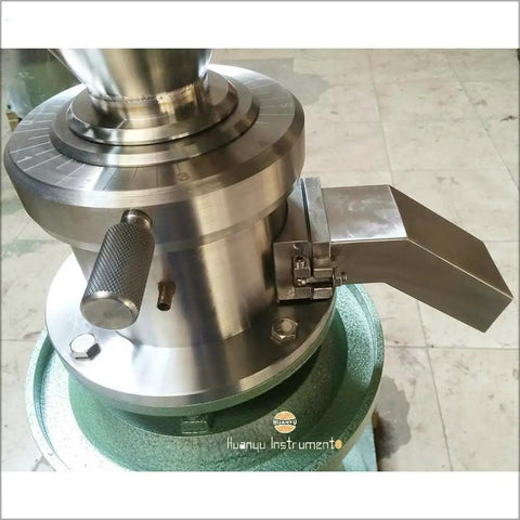 Close-up of JM120 Commercial Vertical Peanut Butter Grinder Mill in Stainless Steel output chute and mechanical details.