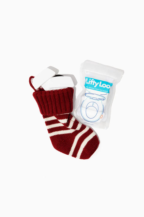 Toilet Seat Handle 2 Pack White Lift More Mess Less Easy Install With Thick 3M Adhesive Curved Bottom Made From Recycled Ocean Plastic Premium Feel Bathroom Accessory package next to red and white striped sock.