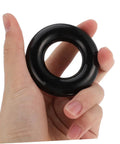 Close-up of hand holding black ring from Two Pack Weighted Golf Swing Trainer Rings For Beginners, Warm Up Practice Tool.