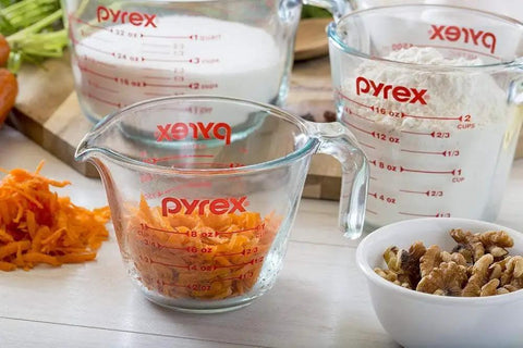 Two Piece Glass Measuring Cups Set With 1 Cup And 2 Cup Sizes filled with ingredients for easy prep baking