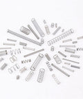 Stainless Steel Y Shaped Micro Compression Springs Kit, 10 Piece Set, Wire Diameters 0.1mm Through 0.8mm scattered on white background
