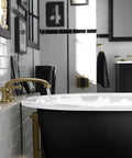 Heavy Duty 1-1/2 Inch Adjustable Pop Up Bath Drain With Solid Brass Tailpiece in use with a freestanding tub setup.