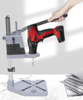 Image showing Rock Solid Drill Press Stand For Hand And Power Drills With Tight Grip Benchtop Mount Adapter holding a drill.