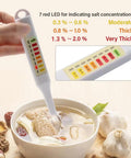 Person using Handheld Salt Concentration Tester Pen With LED Display For Liquid Foods Like Soup And Kitchen Use Quick Accurate Salinity Meter