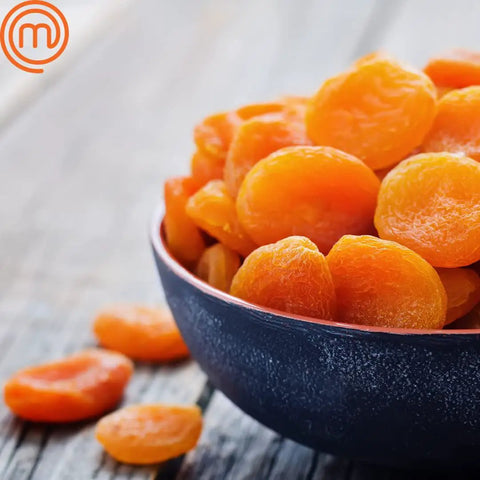 Bowl of dried apricots prepared using the Kickass Efficient Digital Food Dehydrator Featuring Five Generous Trays And Smart Temperature Controls For Whipping Up Crunchy Jerky Dried Fruits And Savory Herb Flakes Fast.